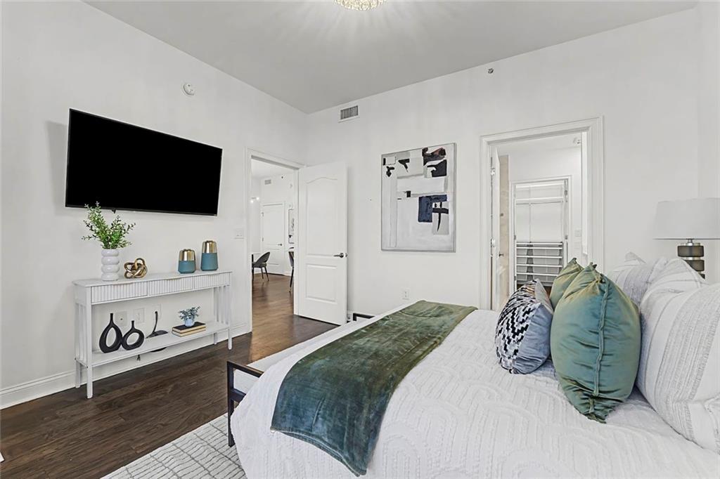 2828 Peachtree Road Northwest, Unit 1704 Atlanta, GA 30305 - Photo 19 of 41 a bedroom with a bed and a flat screen tv