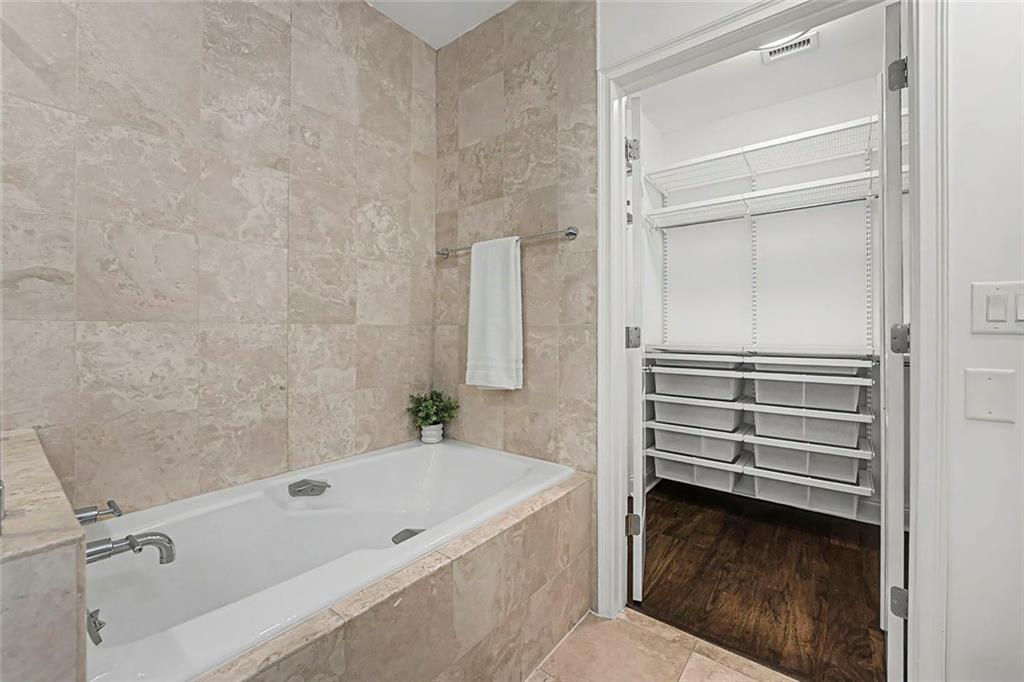 2828 Peachtree Road Northwest, Unit 1704 Atlanta, GA 30305 - Photo 22 of 41 a bathroom with a bathtub and a shower