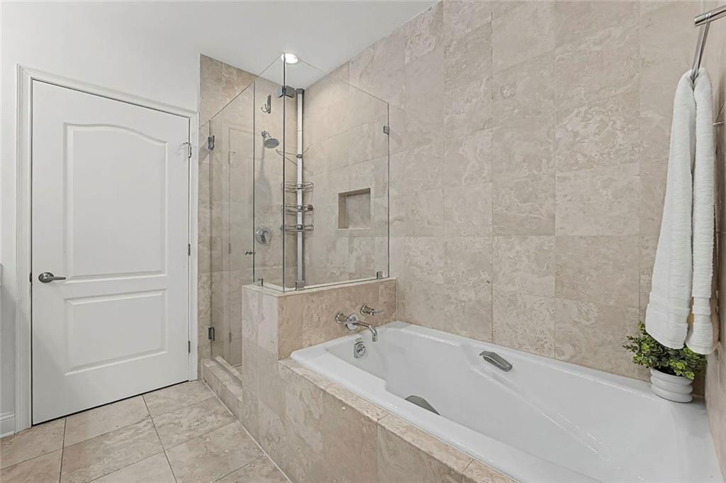 2828 Peachtree Road Northwest, Unit 1704 Atlanta, GA 30305 - Photo 26 of 41 a bathroom with a tub a shower and a sink