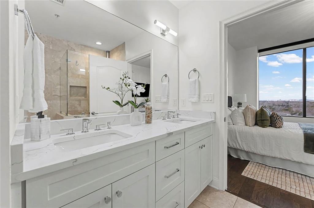 2828 Peachtree Road Northwest, Unit 1704 Atlanta, GA 30305 - Photo 27 of 41 a spacious bathroom with a double vanity sink mirror and next to a window