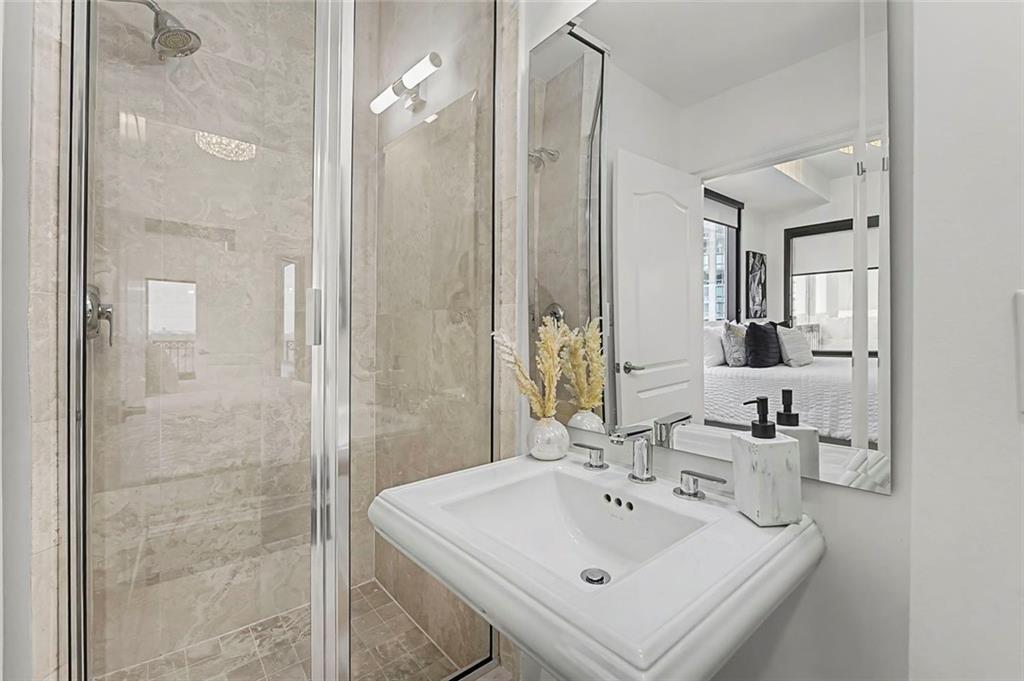 2828 Peachtree Road Northwest, Unit 1704 Atlanta, GA 30305 - Photo 29 of 41 a bathroom with a sink a toilet and shower