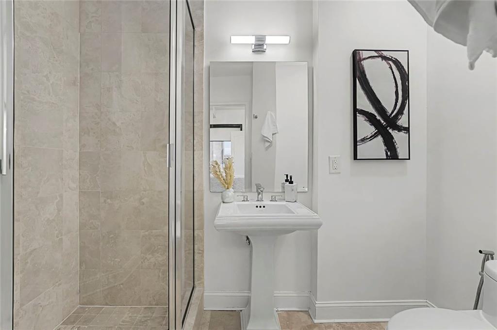 2828 Peachtree Road Northwest, Unit 1704 Atlanta, GA 30305 - Photo 30 of 41 a bathroom with a sink mirror and toilet