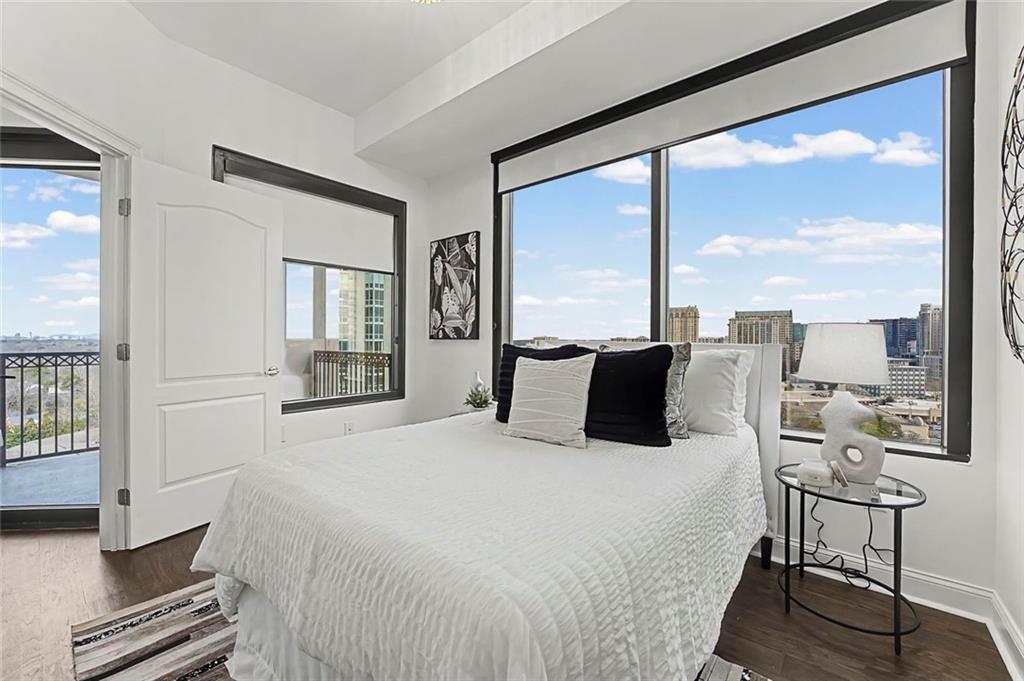 2828 Peachtree Road Northwest, Unit 1704 Atlanta, GA 30305 - Photo 31 of 41 a bedroom with a large bed and a large window with outer view