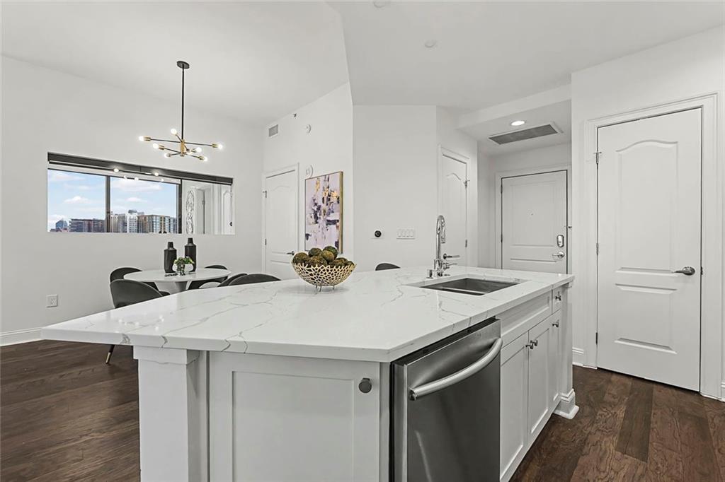 2828 Peachtree Road Northwest, Unit 1704 Atlanta, GA 30305 - Photo 8 of 41 a kitchen with a sink a stove and wooden floor