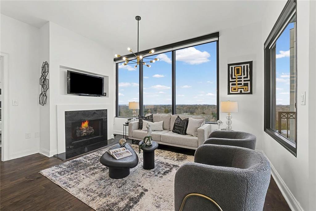 2828 Peachtree Road Northwest, Unit 1704 Atlanta, GA 30305 - Photo 10 of 41 a living room with furniture a flat screen tv and a fireplace
