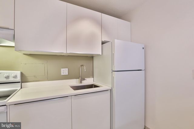 a kitchen with a refrigerator a sink and a stove