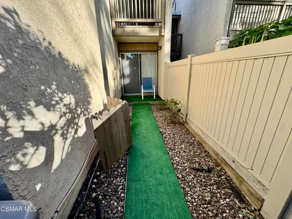 a view of a backyard with wooden fence