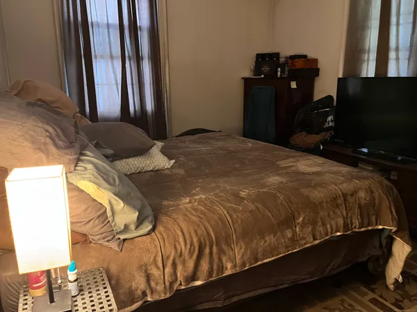 a bedroom with a bed and tv
