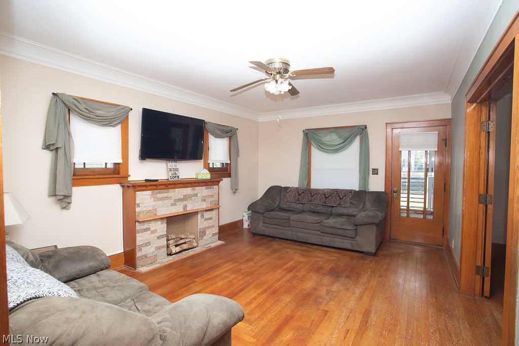 213 Como Street Struthers, OH 44471 - Photo 5 of 25 Living room with wood floors, high ceilings, and fireplace