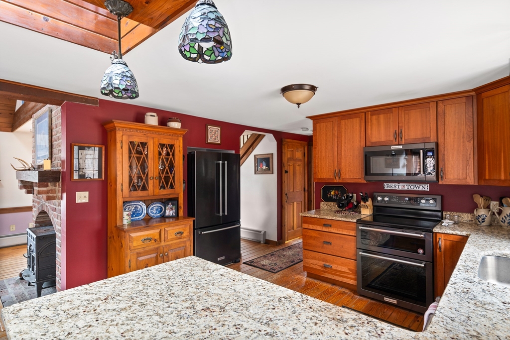 168 Brickyard Road Southampton, MA 01073 - Photo 12 of 42 a kitchen with stainless steel appliances kitchen island granite countertop a refrigerator and a stove top oven