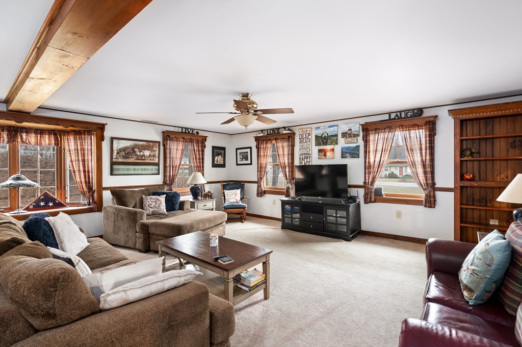 168 Brickyard Road Southampton, MA 01073 - Photo 19 of 42 a living room with furniture a flat screen tv and a large window