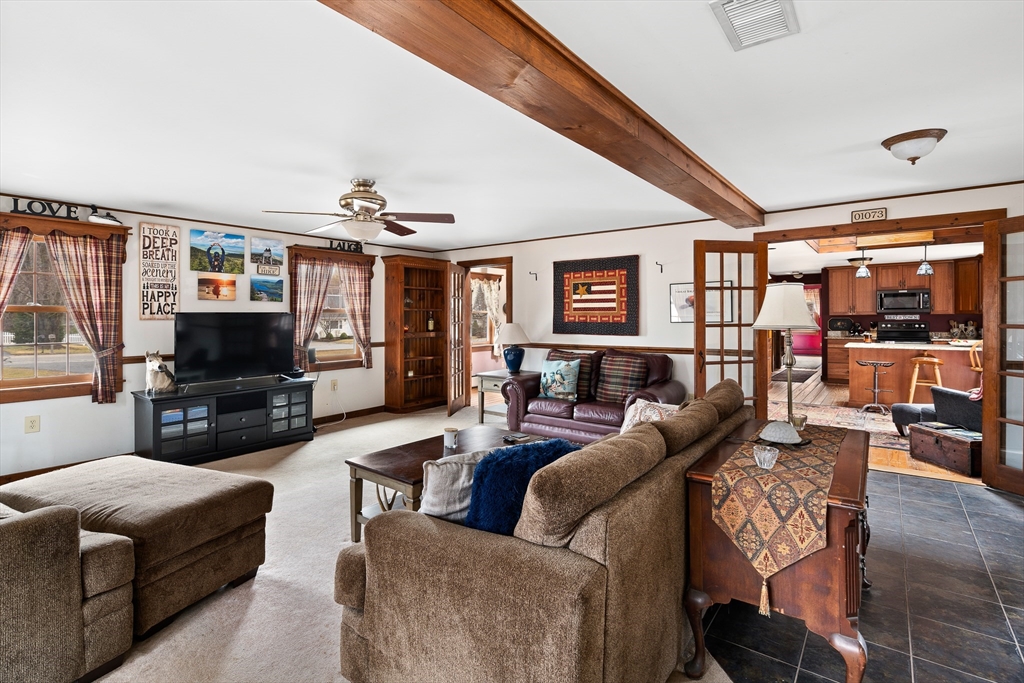 168 Brickyard Road Southampton, MA 01073 - Photo 23 of 42 a living room with furniture and a flat screen tv
