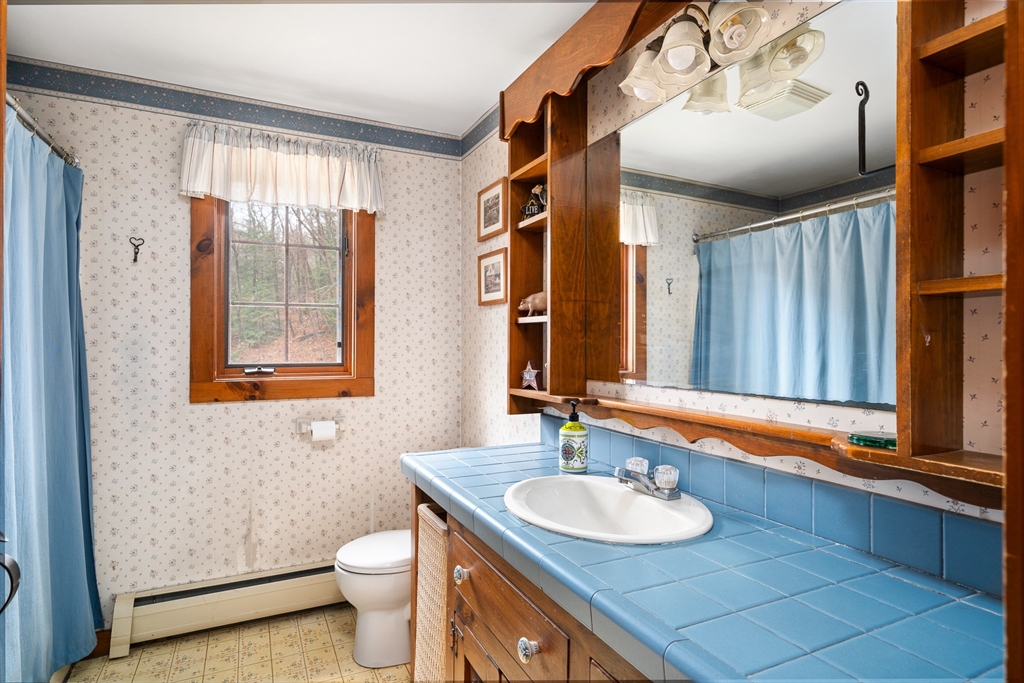 168 Brickyard Road Southampton, MA 01073 - Photo 25 of 42 a bathroom with a toilet sink and mirror
