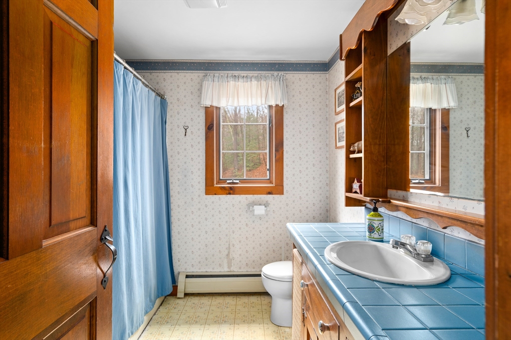 168 Brickyard Road Southampton, MA 01073 - Photo 26 of 42 a bathroom with a granite countertop sink toilet and shower
