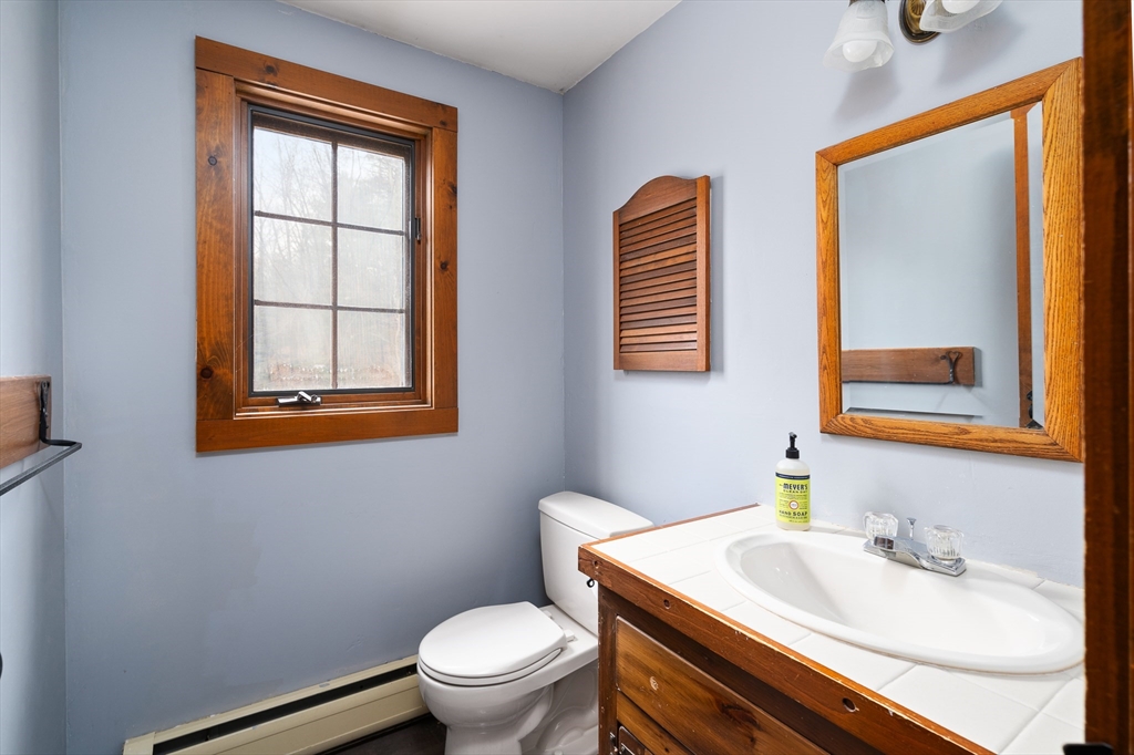 168 Brickyard Road Southampton, MA 01073 - Photo 33 of 42 a bathroom with a toilet sink and mirror