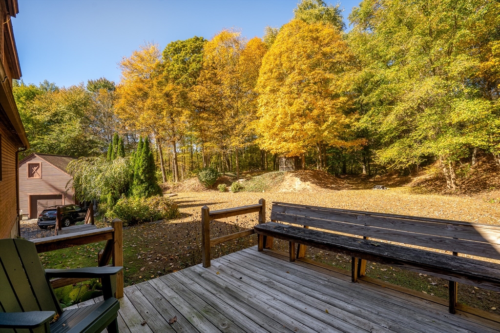 168 Brickyard Road Southampton, MA 01073 - Photo 4 of 42 a view of a wooden bench and trees in the backyard
