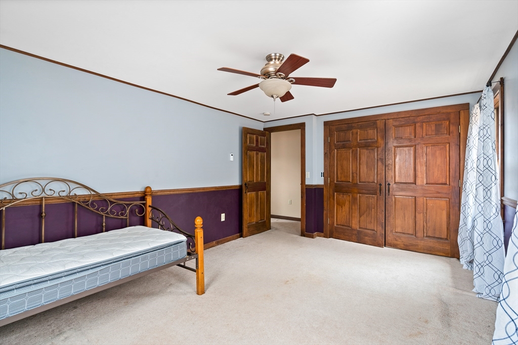168 Brickyard Road Southampton, MA 01073 - Photo 41 of 42 a spacious bedroom with a bed and a ceiling fan