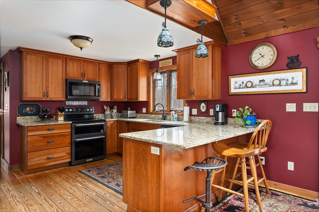 168 Brickyard Road Southampton, MA 01073 - Photo 10 of 42 a kitchen with stainless steel appliances granite countertop a stove a sink dishwasher and cabinets with wooden floor