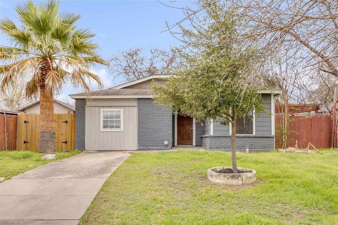7004 Trendal Lane Austin, TX 78744 - Photo 1 of 1 a front view of house with yard and trees