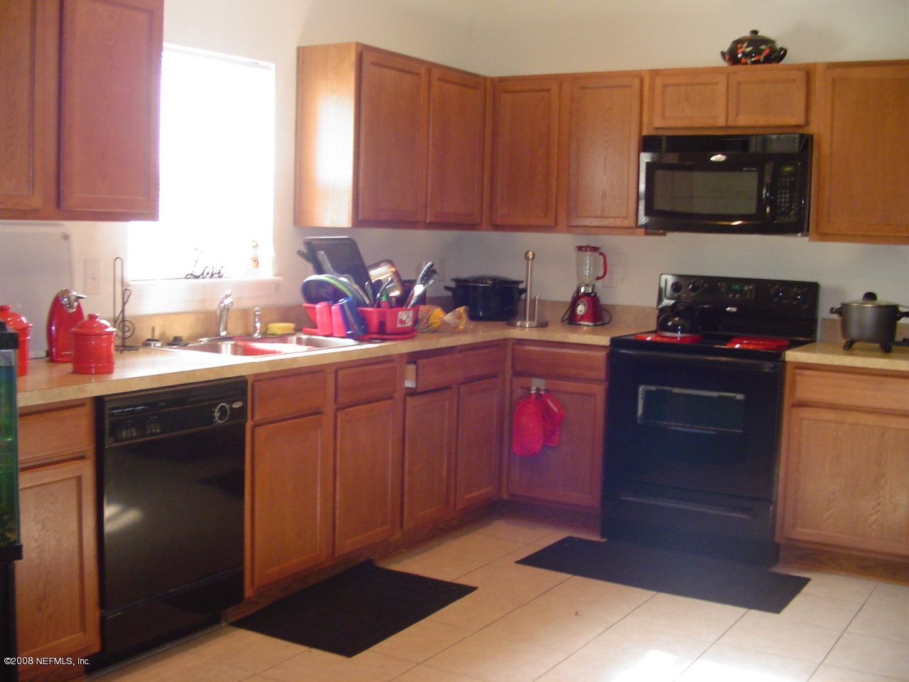 7260 Rampart Ridge Circle West Jacksonville, FL 32244 - Photo 10 of 16 a kitchen with a sink a stove and cabinets