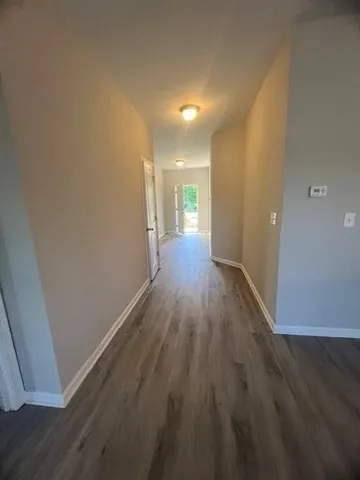 a view of a room with wooden floor