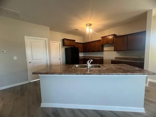 a large kitchen with kitchen island a sink and a stove