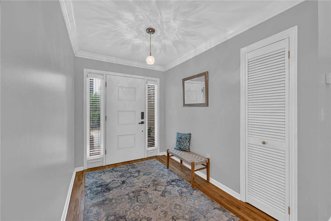 433 Latham Road Easley, SC 29640 - Photo 27 of 50 A welcoming entry features hardwood floors, crown molding, and a modern light fixture.