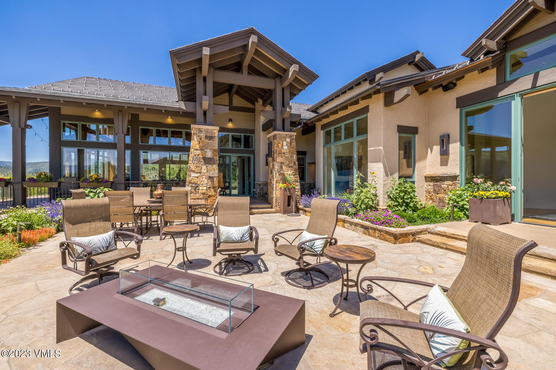 81 Elk Run Edwards, CO 81632 - Photo 17 of 62 a view of a patio with couches table and chairs under an umbrella