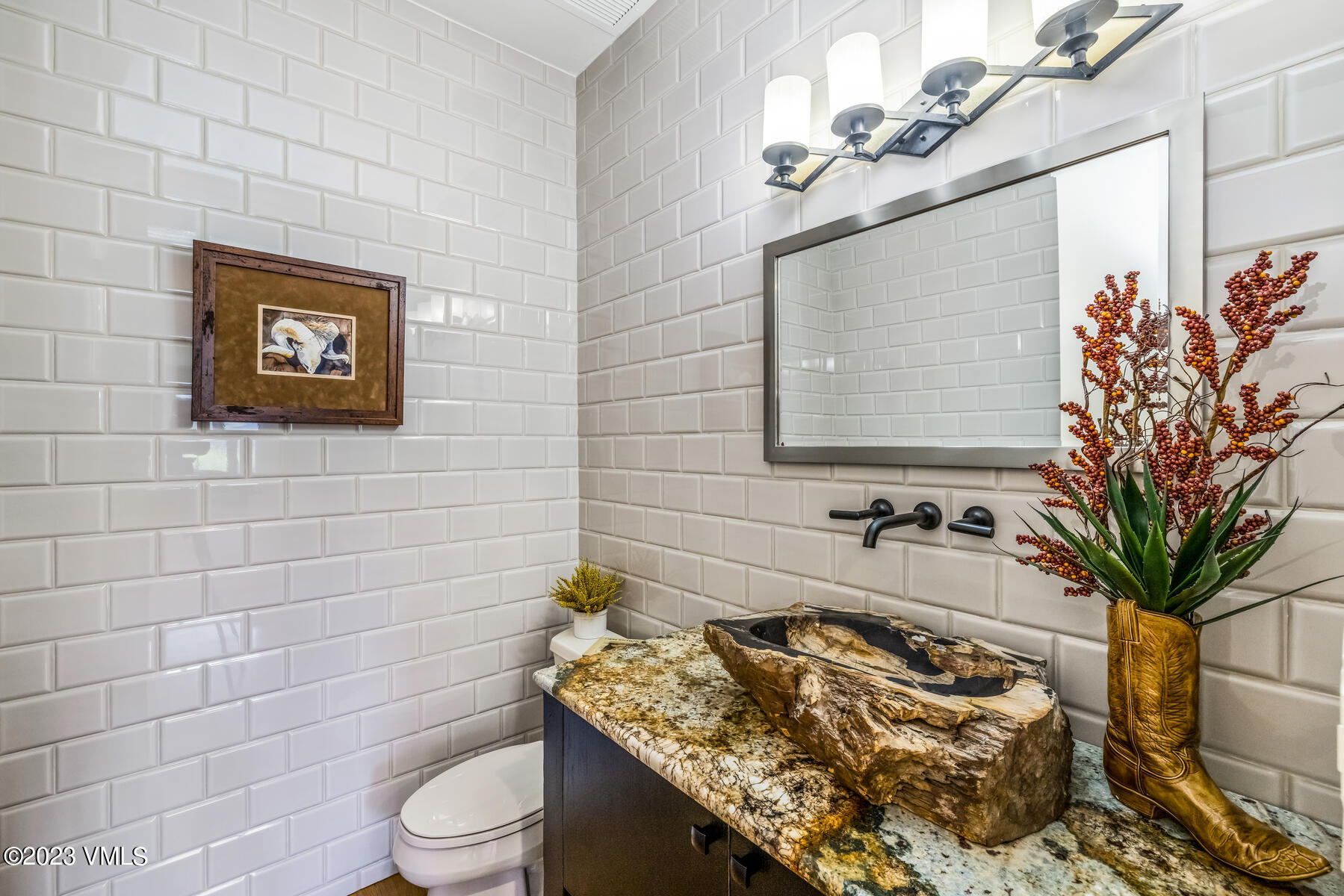 81 Elk Run Edwards, CO 81632 - Photo 43 of 62 a bathroom with a granite countertop sink a toilet and a mirror
