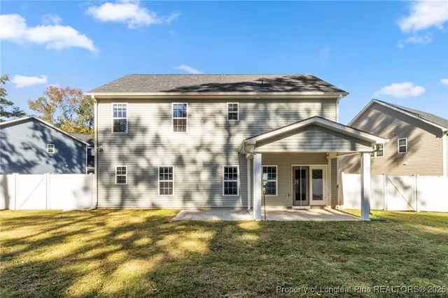 a view of a white house with a swimming pool