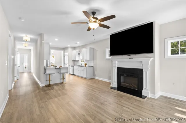 a living room with furniture a fireplace and a flat screen tv