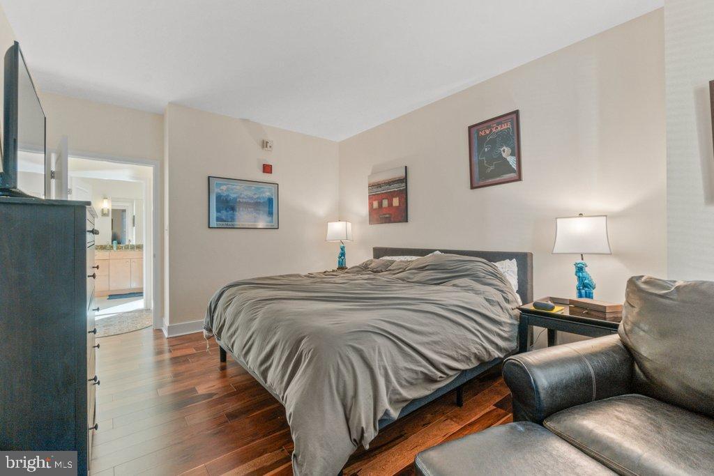 675 President Street, Unit 1404 Baltimore, MD 21202 - Photo 12 of 31 a bed room with a bed a couch and cabinets