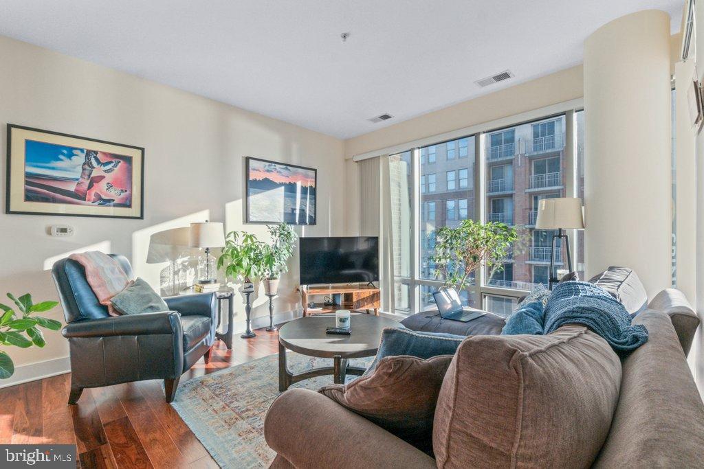 675 President Street, Unit 1404 Baltimore, MD 21202 - Photo 20 of 31 a living room with furniture a flat screen tv and a large window