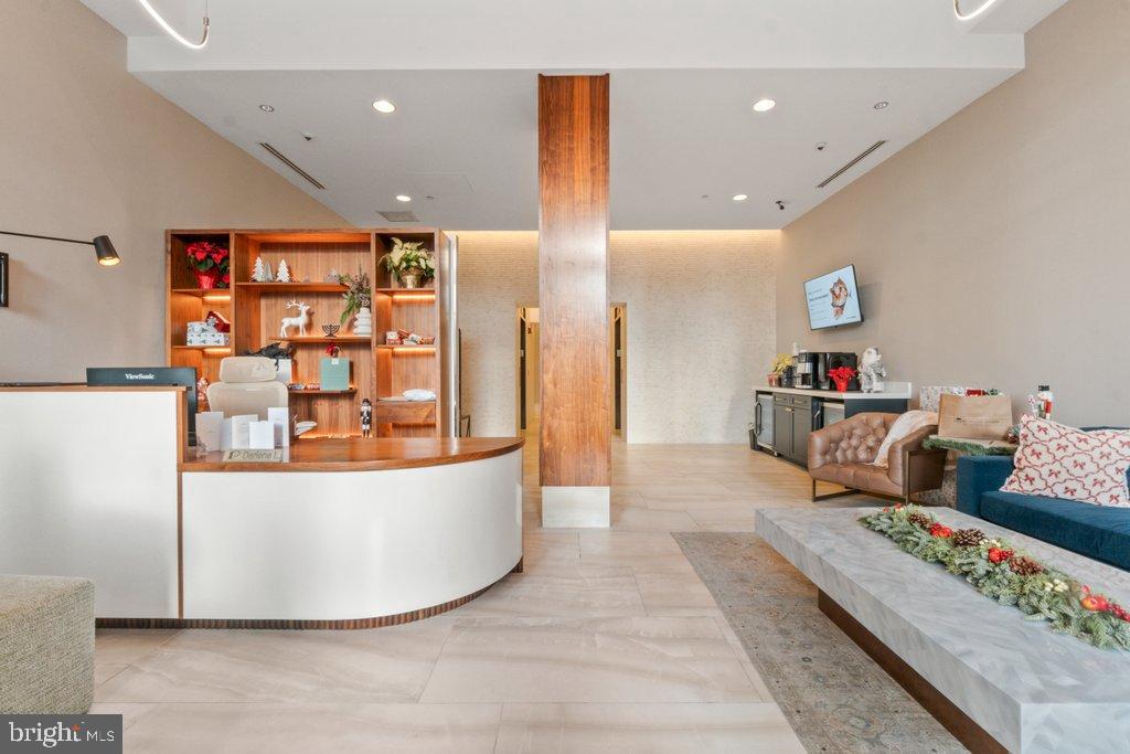 675 President Street, Unit 1404 Baltimore, MD 21202 - Photo 5 of 31 a living room with furniture and a flat screen tv
