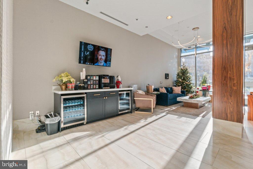 675 President Street, Unit 1404 Baltimore, MD 21202 - Photo 6 of 31 a living room with furniture a rug and a window