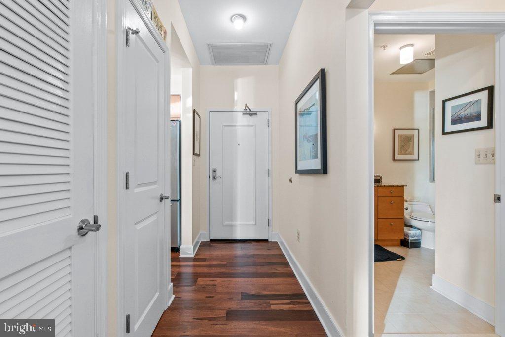 675 President Street, Unit 1404 Baltimore, MD 21202 - Photo 8 of 31 a view of a hallway with wooden floor and staircase