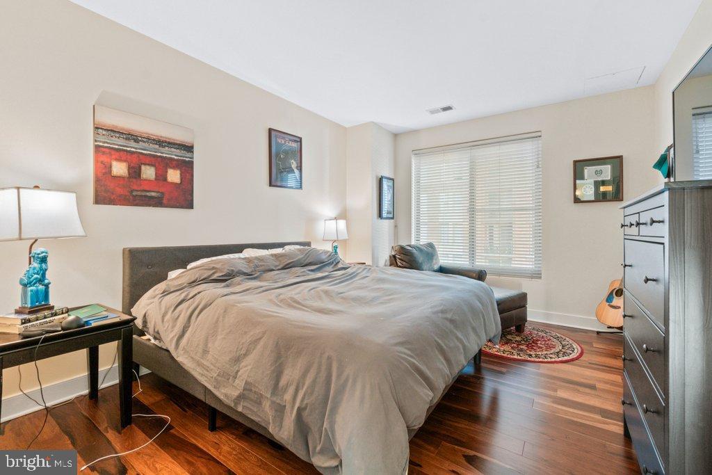 675 President Street, Unit 1404 Baltimore, MD 21202 - Photo 10 of 31 a bedroom with bed and a window