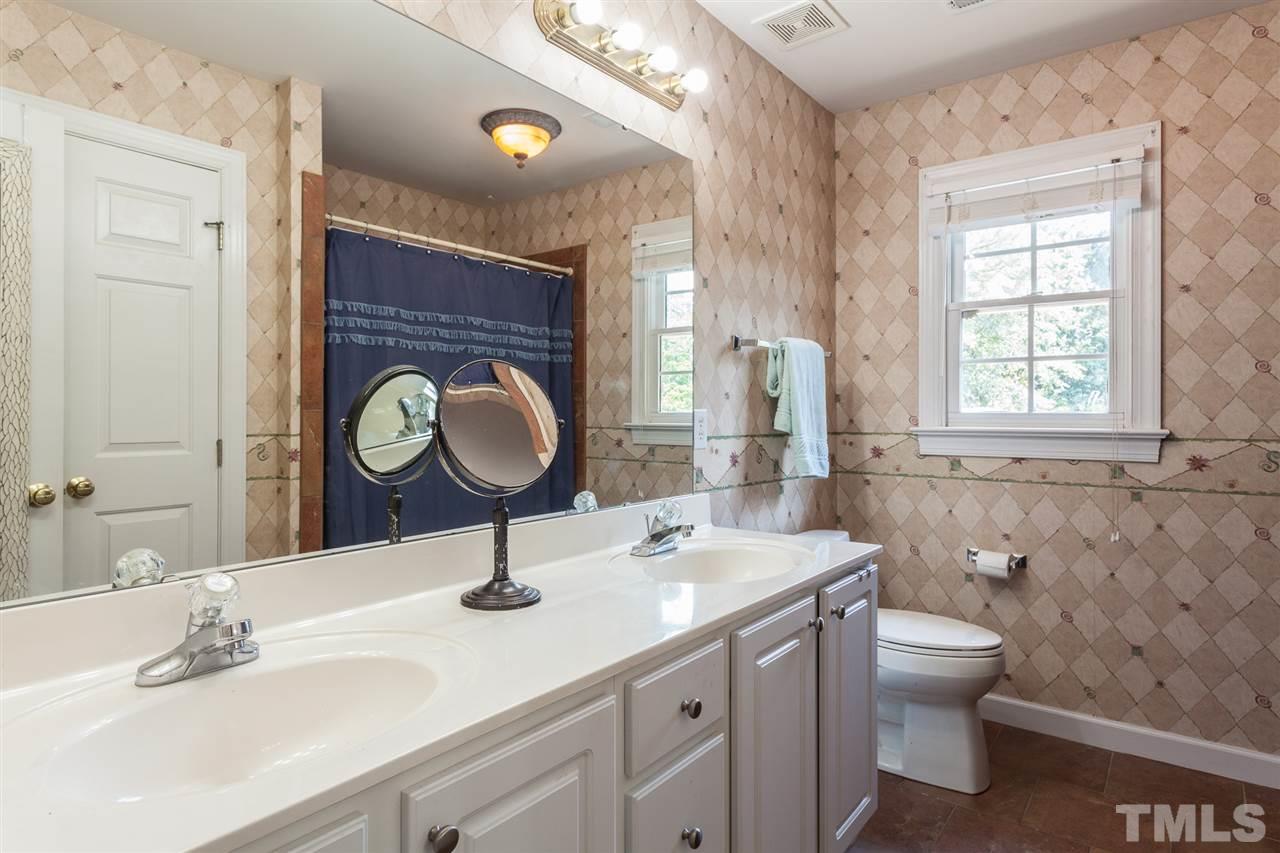 2613 Lizei Street Raleigh, NC 27616 - Photo 23 of 25 a bathroom with a sink a toilet and a mirror