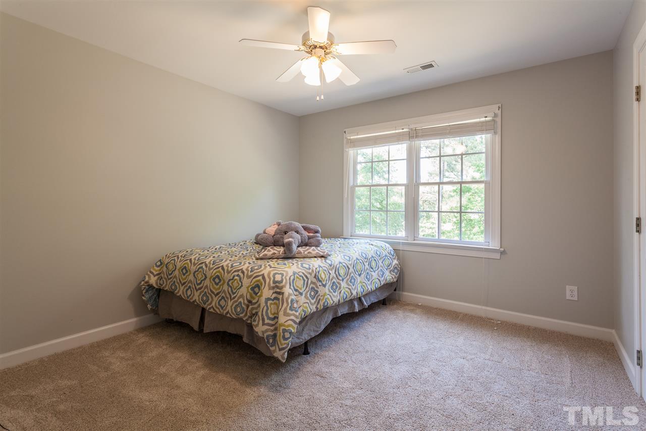 2613 Lizei Street Raleigh, NC 27616 - Photo 24 of 25 a bedroom with a bed and a chandelier fan