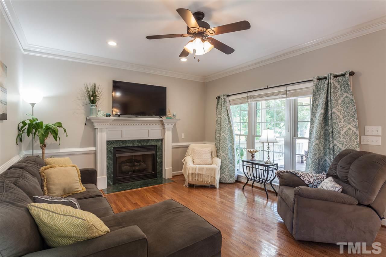 2613 Lizei Street Raleigh, NC 27616 - Photo 9 of 25 a living room with furniture a flat screen tv and a fireplace