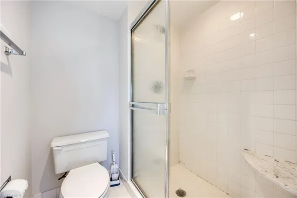 a bathroom with a toilet and a shower