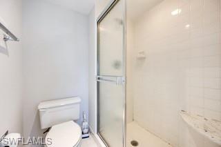 1645 Spoonbill Lane, Unit C Naples, FL 34105 - Photo 14 of 50 Bathroom featuring a shower stall and toilet