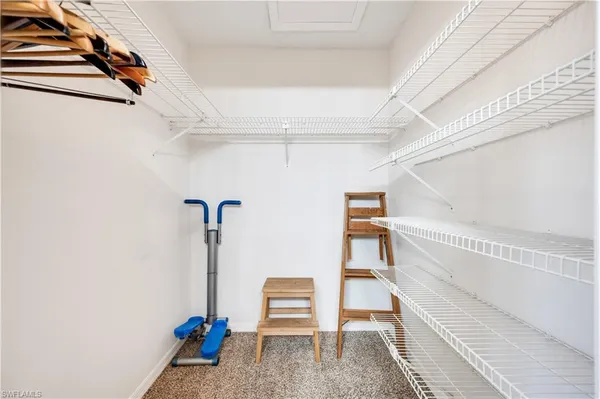 a view of a room with wooden floor and white walls
