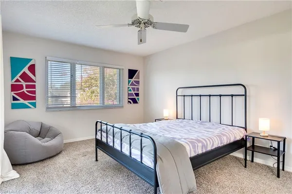 a bedroom with a bed couch and window
