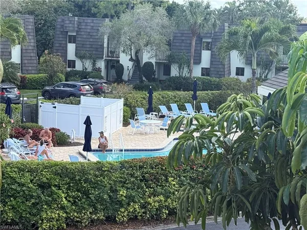 a view of a house with backyard and sitting area