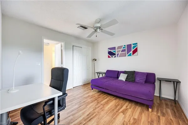 a living room with furniture and wooden floor