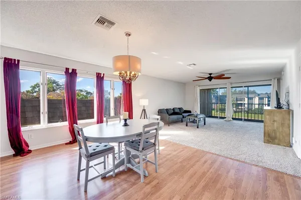 a view of a dining room with furniture window and wooden floor