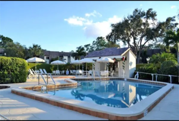 a view of a swimming pool with an outdoor seating