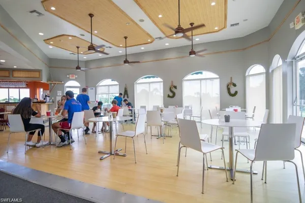 a view of a dining room with furniture chandelier and glass door