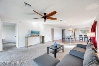 1645 Spoonbill Lane, Unit C Naples, FL 34105 - Photo 5 of 50 Living room with carpet floors, a textured ceiling, and a ceiling fan